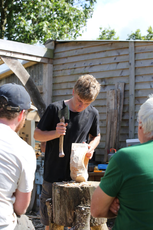 Felix The Wood axing out a wooden spoon at the workshop of the cornish woodsmith