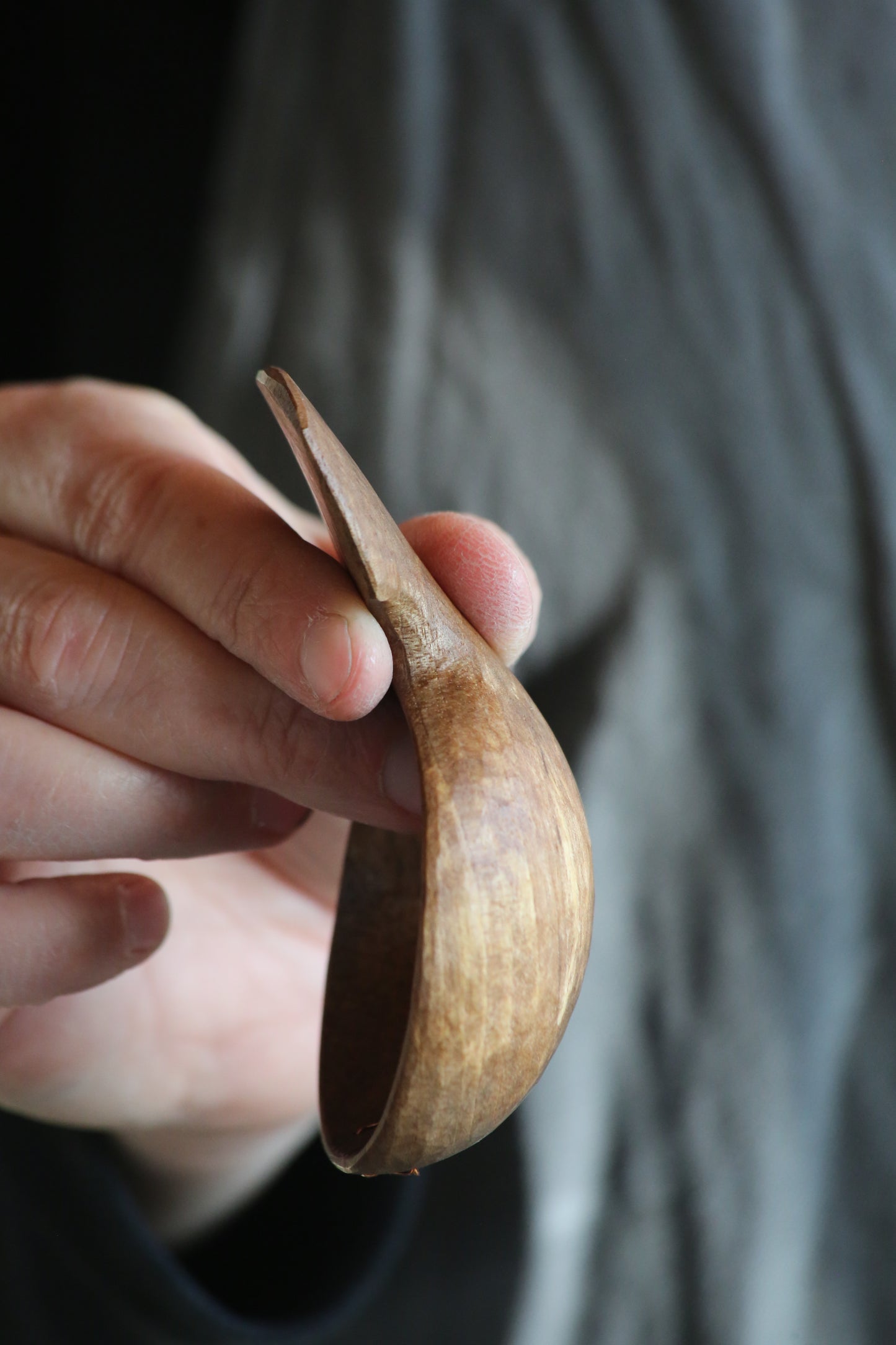 Side profile of a hand carved walnut coffee scoop