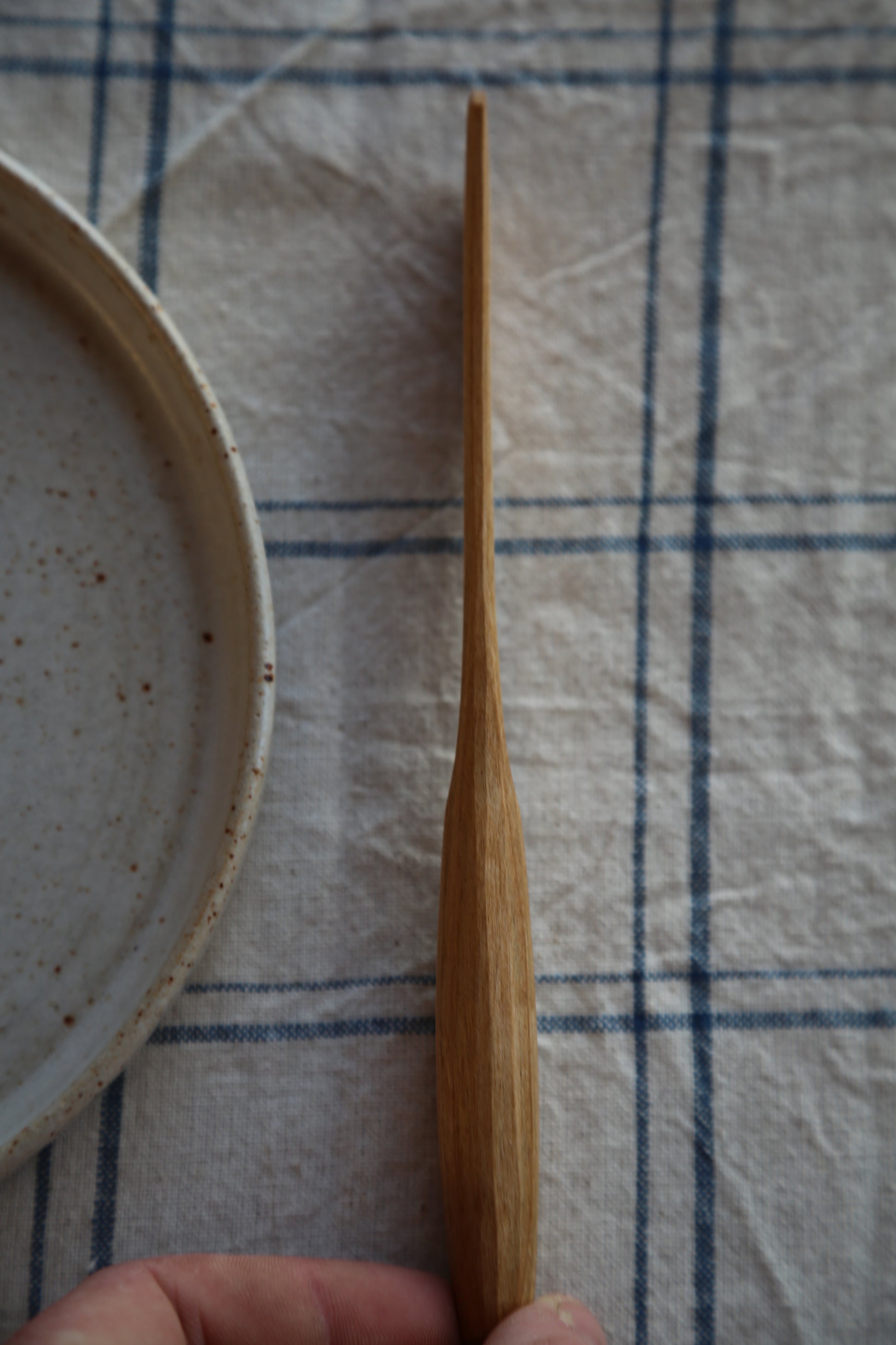 Side profile of a handcarved cherry wood butter knife 